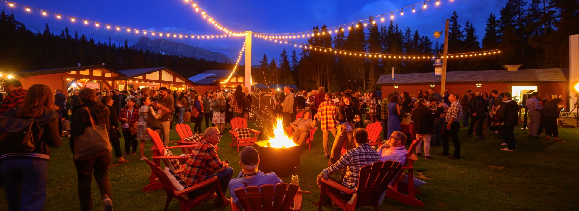 a collective of event attendees, creating emotional connections around a fire pit